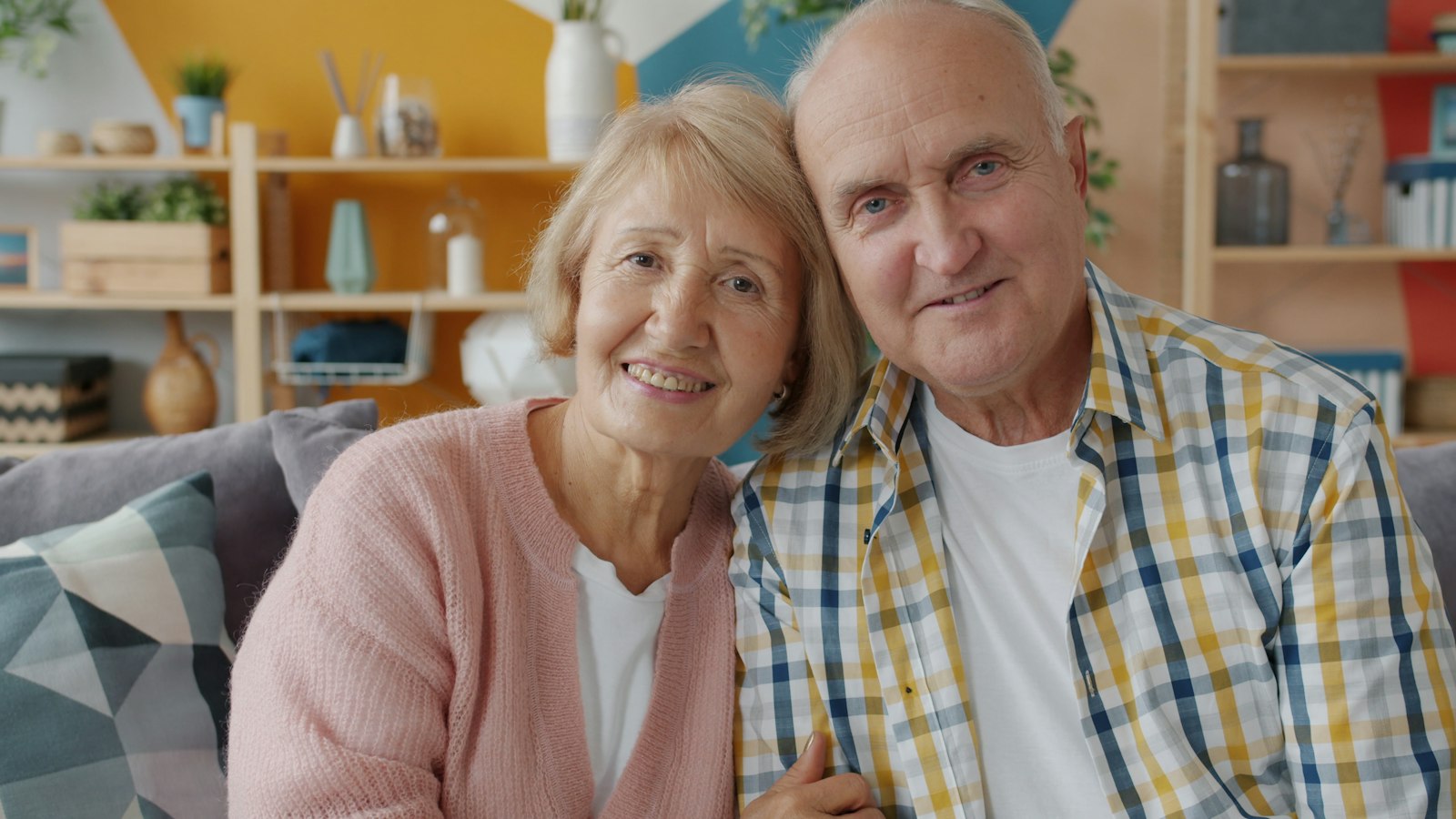 An older couple relaxing together on their couch